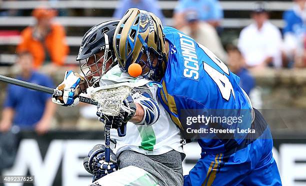 Brendan Mundorf of the Chesapeake Bayhawks and Brett Schmidt of the Charlotte Hounds collide during their game at American Legion Memorial Stadium on...