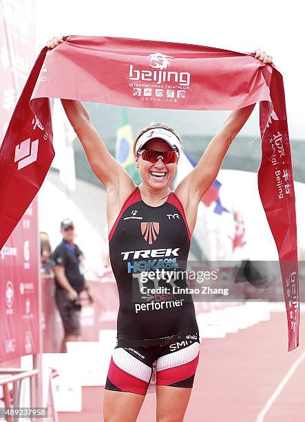 Lauren Goss of United States celebrates after winning the Women's professional group during the 2015 Beijing International Triathlon at Beijing...