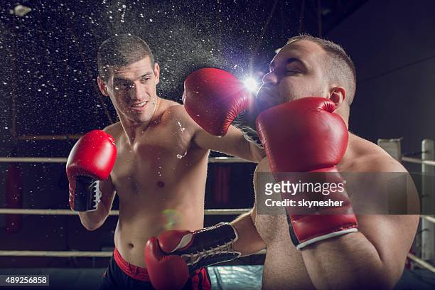 boxers fighting in boxing ring. - knockout punch stock pictures, royalty-free photos & images