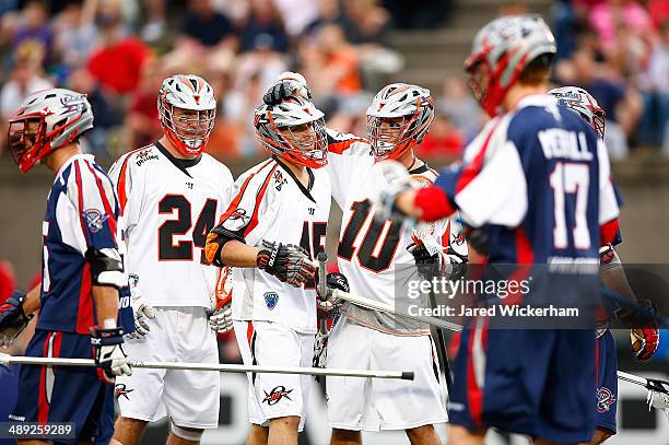 Domenic Sebestiani of the Denver Outlaws is congratulated on his goal by teammates in the first half against the Boston Cannons at Harvard Stadium on...