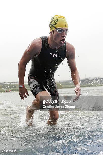 Josh Amberger of Australia finishes the swimming stage during the 2015 Beijing International Triathlon at Beijing Garden Expo on September 20, 2015...