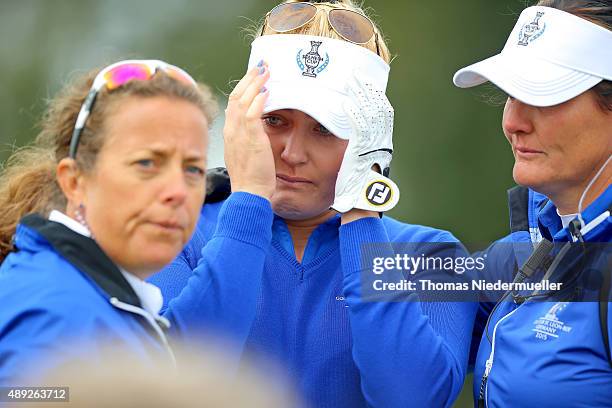 Charley Hull of the European Team in tears on the 18th green where she is being comforted by Fanny Sunesson and European Team vice captain Maria...