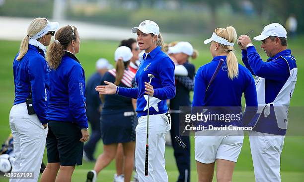 Suzann Pettersen of the European team trying to explain to her captain Carin Koch the length of putt that she did not concede to Alison Lee on the...
