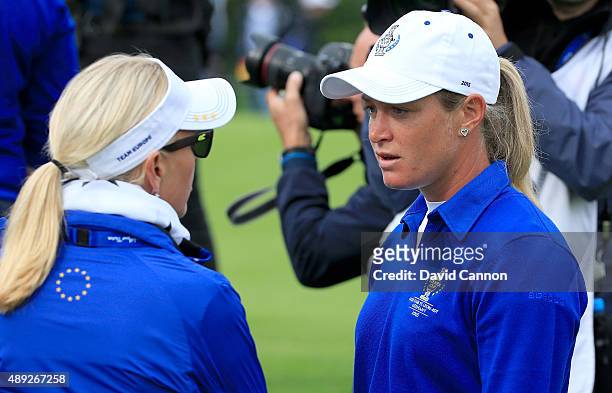 Suzann Pettersen of the European team in deep discussion with her captain Carin Koch about the length of putt that she did not concede to Alison Lee...