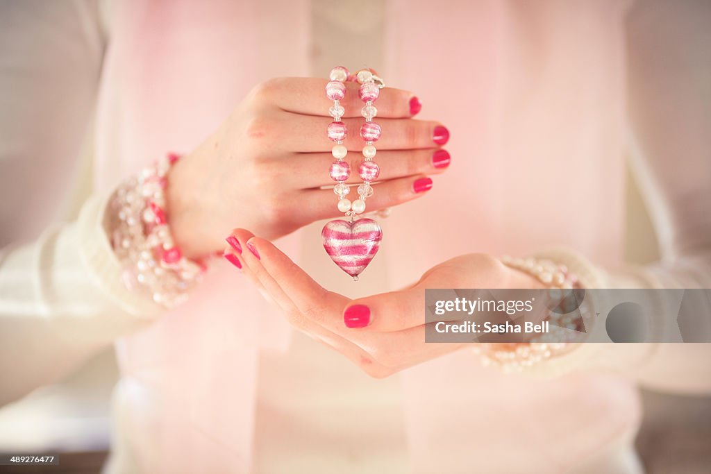 GIrl holding necklace