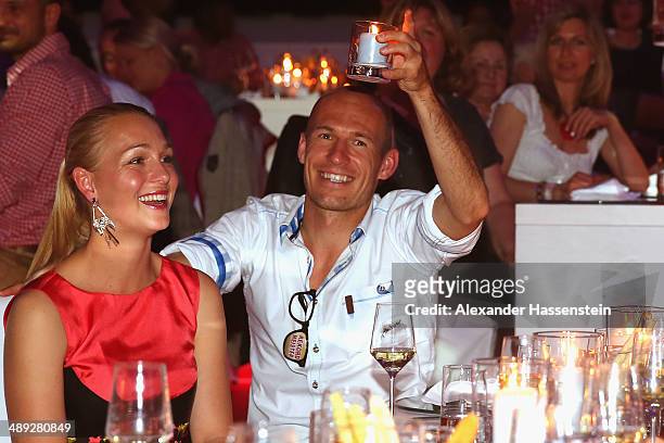 Arjen Robben of Bayern Muenchen celebrates with his wife Bernadien Robben during the official Champions party at Postpalast on May 10, 2014 in...