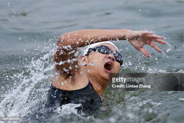 Athletes compete in the swimming stage during the 2015 Beijing International Triathlon at Beijing Garden Expo on September 20, 2015 in Beijing, China.