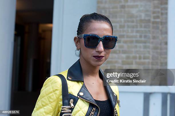 Fashion blogger Talina Naviede wears vintage Moschino bag, Moschino jacket, Anna Karin Karlsson sunglasses and Urban Outfitters top on day 2 during...