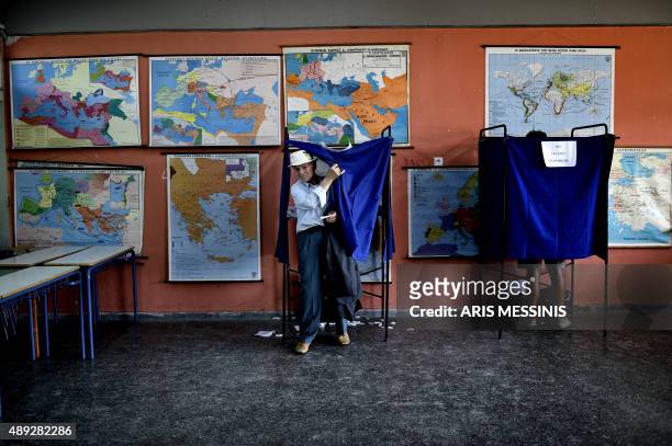Man leaves a polling booth at a polling station in central Athens on September 20, 2015. Over 9.8 million Greeks were registered to vote for a new...