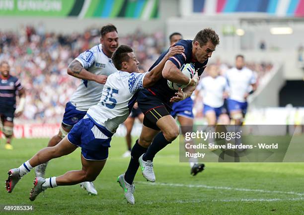 Chris Wyles of the United States is tackled by Tim Nanai-Williams of Samoa as he breaks clear to score his teams opening try during the 2015 Rugby...