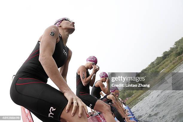 Caroline Steffen of Switzerland and Lauren Goss of United States prepares to start the race before the swimming stage of the 2015 Beijing...