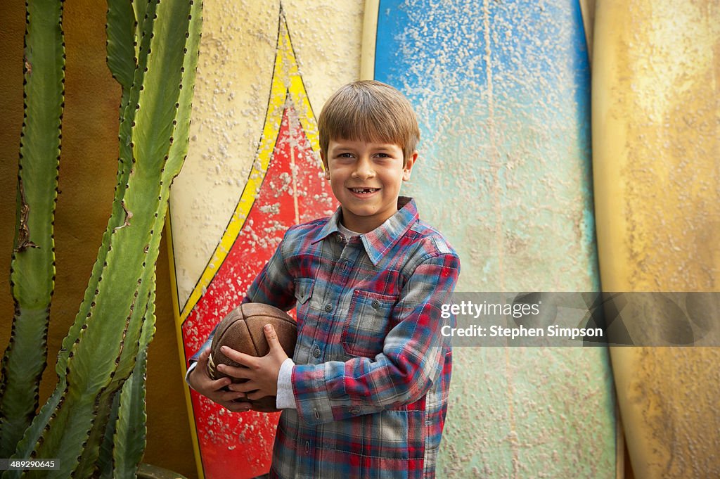 Backyard portrait of boy with surfboards