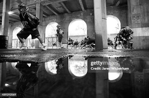 Jack Rice of the Boston Cannons and his teammates warm up underneath Harvard Stadium following the first half against the Denver Outlaws on May 10,...