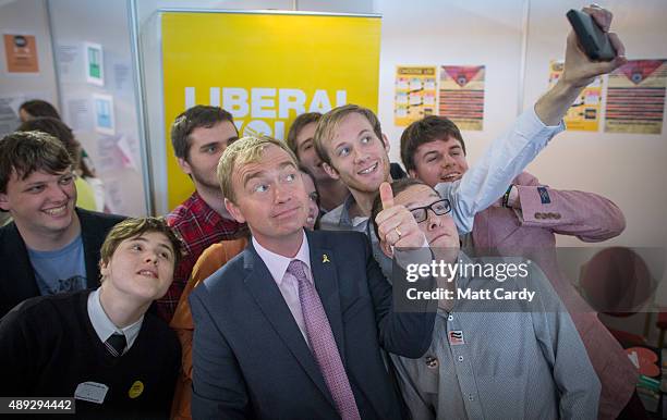 Leader of the Liberal Democrats Tim Farron takes a selfie photograph with young Liberals as he visits the trade and exhibition stands on the second...