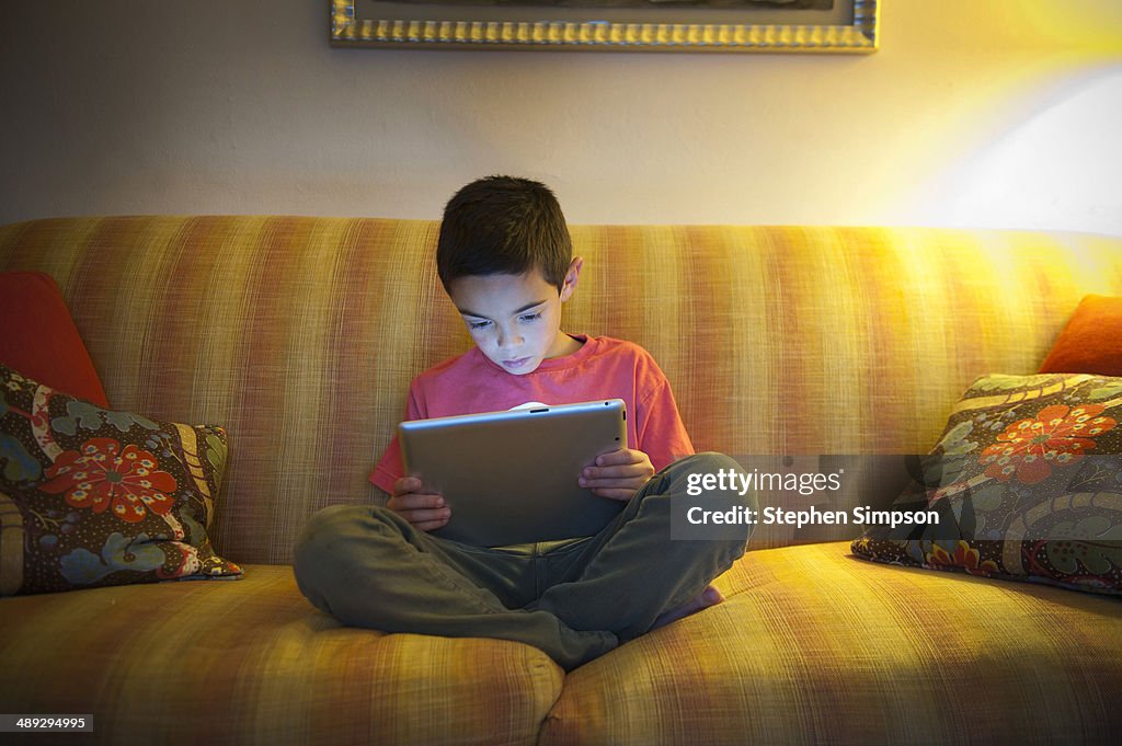 Young boy working/playing on his tablet computer