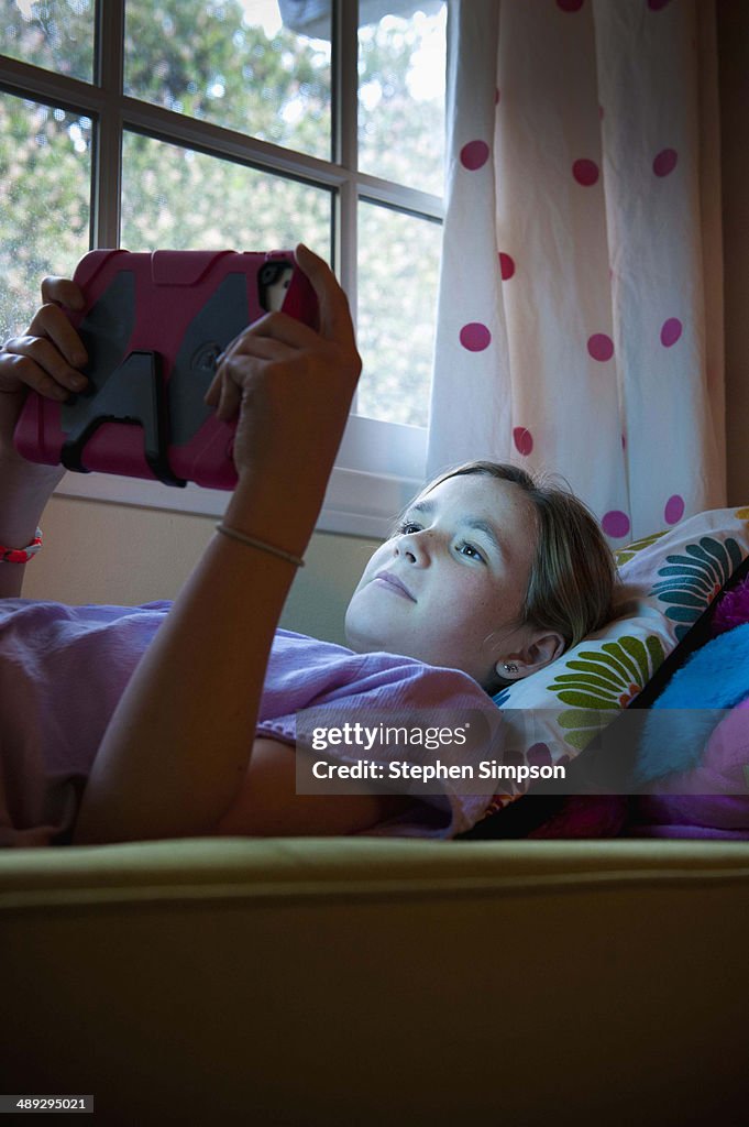 Teen girl working/playing on her tablet computer