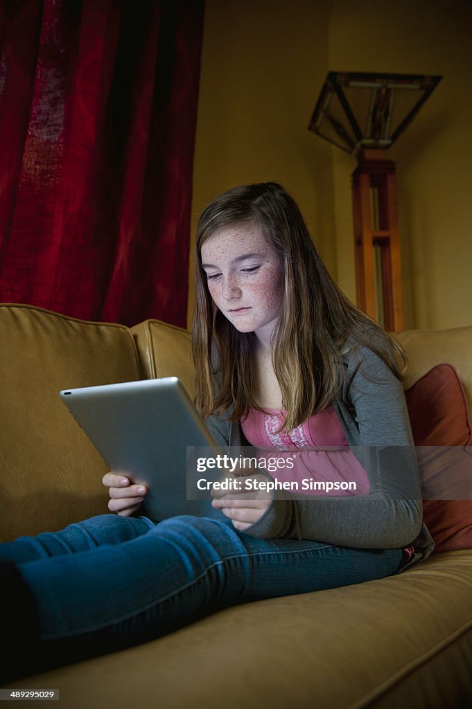 Teen girl working/playing on her tablet computer