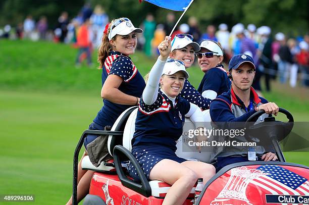 Lexi Thompson, Morgan Pressel, Paula Creamer and Brittany Lang celebrate on a team buggy after the match was decided during the final day singles...