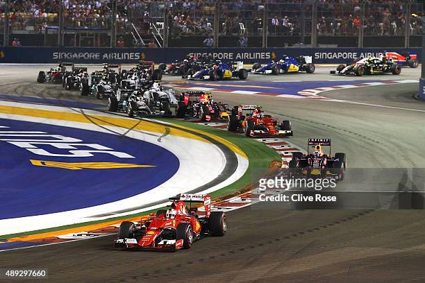 Sebastian Vettel of Germany and Ferrari leads Daniel Ricciardo of Australia and Infiniti Red Bull Racing, Kimi Raikkonen of Finland and Ferrari,...