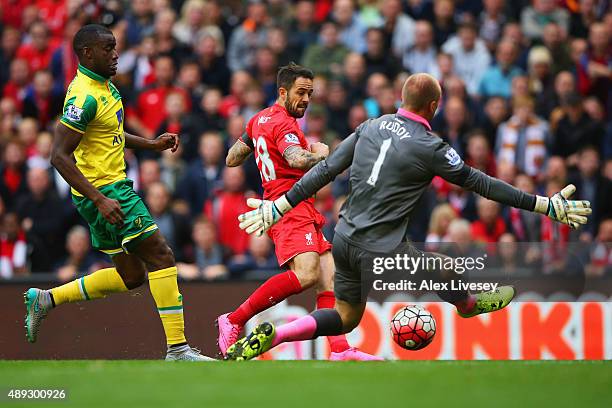 Danny Ings of Liverpool shoots past goalkeeper John Ruddy of Norwich City to score their first goal during the Barclays Premier League match between...