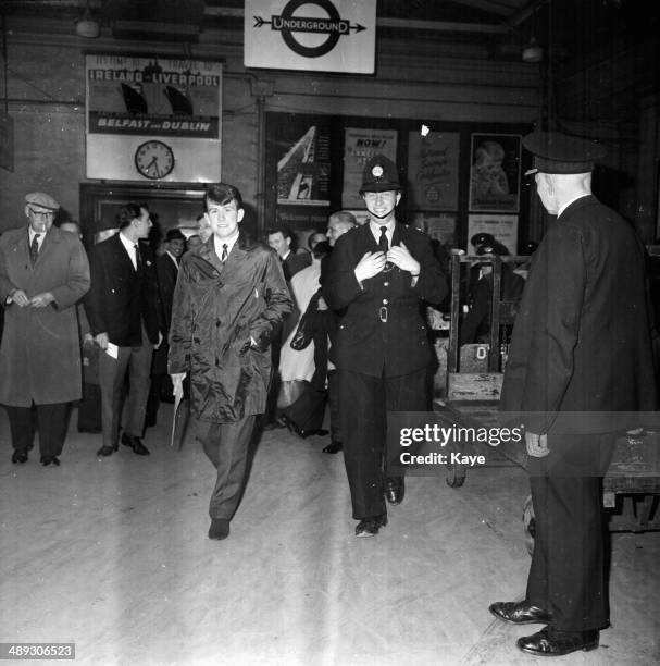 Preston Football Club's Howard Kendall, being escorted through a train station, in the city for his teams match at Wembley Stadium, London, April...