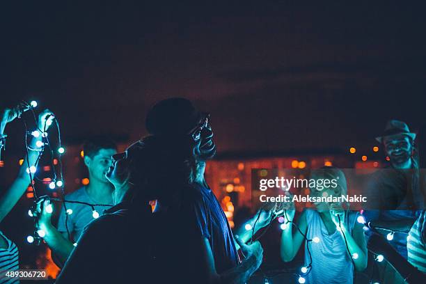 love generation - rooftop party lights stock pictures, royalty-free photos & images