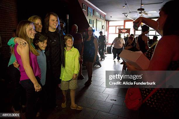 American Idol" finalist Caleb Johnson poses with fans at The Emerald Lounge during his homecoming on May 10, 2014 in Asheville, North Carolina.