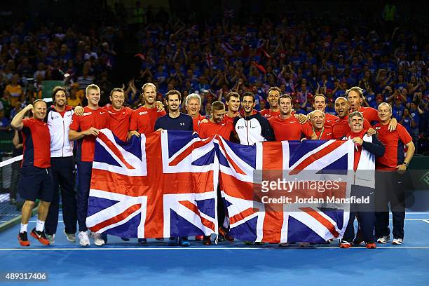 Andy Murray of Great Britain celebrates victory in his match against Bernard Tomic of Australia with his team-mates during Day Three of the Davis...