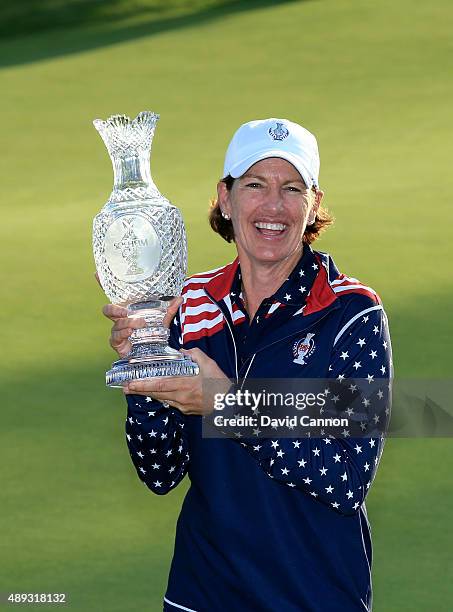 Juli Inkster victorious United States Team captain proudly holds the Solheim Cup trophy after the closing ceremony during the final day singles...