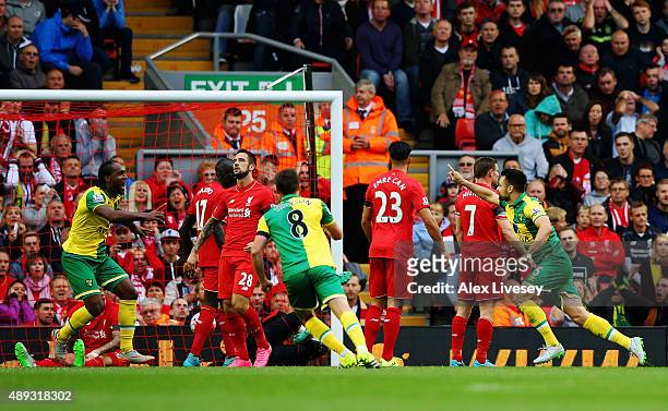 Russell Martin of Norwich City celebrates as he scores their first and equalising goal during the Barclays Premier League match between Liverpool and...