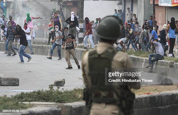 Kashmiri Muslim protesters try to throw stones at security men during a protest, on September 20, 2015 in Srinagar, India. Unidentified gunmen shot...