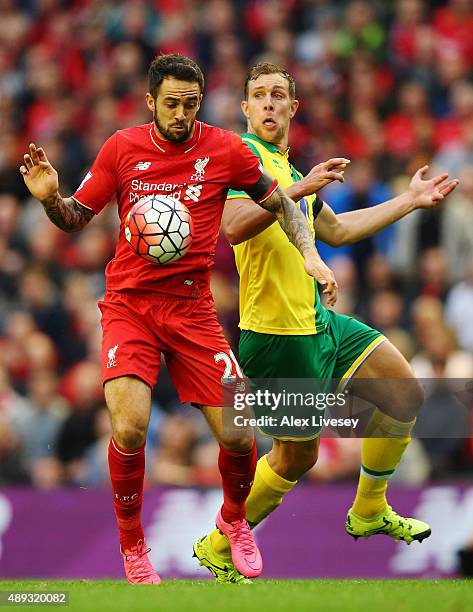 Danny Ings of Liverpool battles with Steven Whittaker of Norwich City during the Barclays Premier League match between Liverpool and Norwich City at...