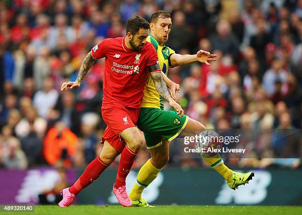 Danny Ings of Liverpool battles with Steven Whittaker of Norwich City during the Barclays Premier League match between Liverpool and Norwich City at...