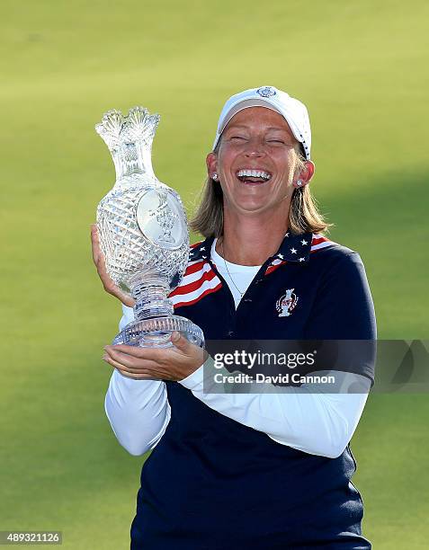 Angela Stanford of the United States Team proudly holds the Solheim Cup trophy after the closing ceremony during the final day singles matches in the...