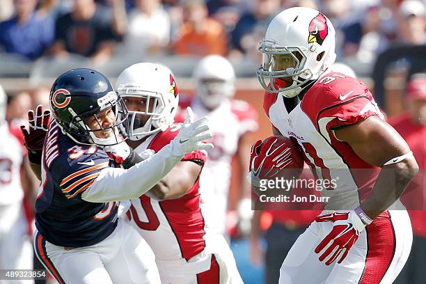 David Johnson of the Arizona Cardinals returns the opening kickoff for a touchdown against the Chicago Bears as Stepfan Taylor of the Arizona...