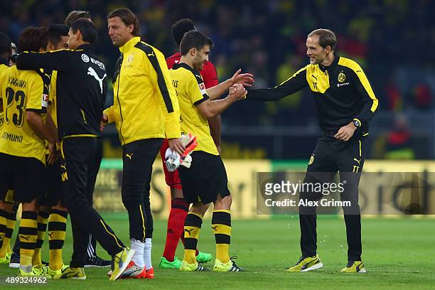 Head coach Thomas Tuchel of Dortmund celebrates with Sokratis Papastathopoulos after the Bundesliga match between Borussia Dortmund and Bayer...
