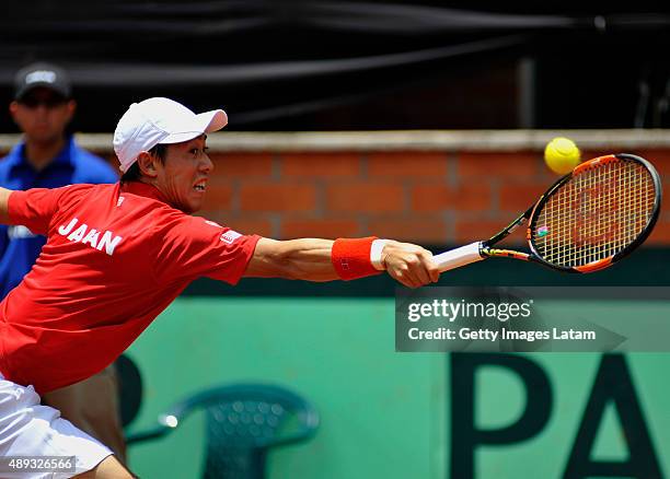 Kei Nishikori of Japan returns a forehand shot during the Davis Cup World Group Play-off singles match between Santiago Giraldo of Colombia and Kei...