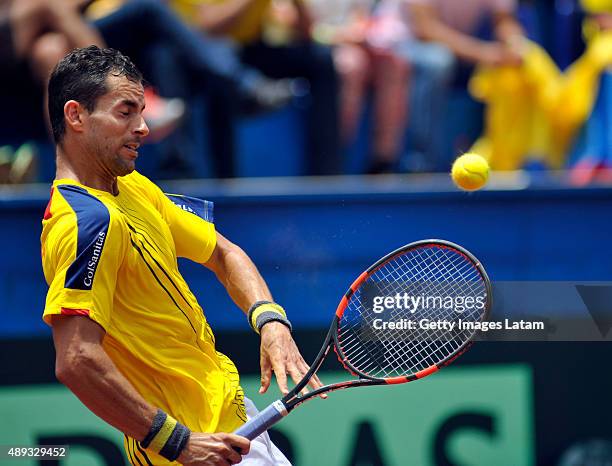 Santiago Giraldo of Colombia returns a backhand shot during the Davis Cup World Group Play-off singles match between Santiago Giraldo of Colombia and...