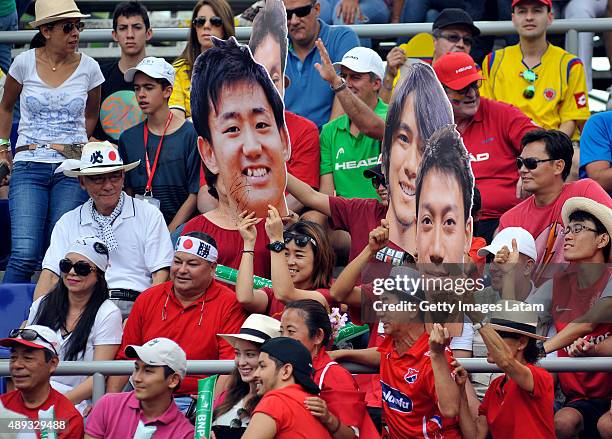 Japanese supporters cheer for their team during the Davis Cup World Group Play-off singles match between Santiago Giraldo of Colombia and Kei...