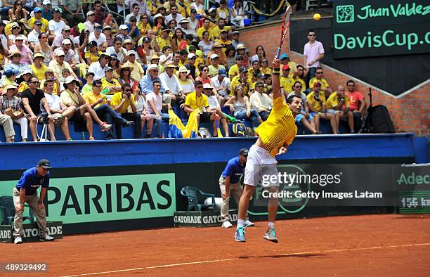 Santiago Giraldo of Colombia serves a ball during the Davis Cup World Group Play-off singles match between Santiago Giraldo of Colombia and Kei...