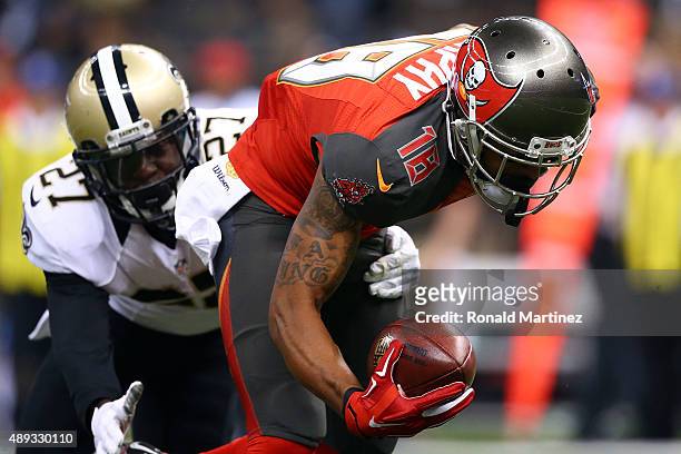 Louis Murphy of the Tampa Bay Buccaneers is brought down by Damian Swann of the New Orleans Saints during the second quarter of a game at the...