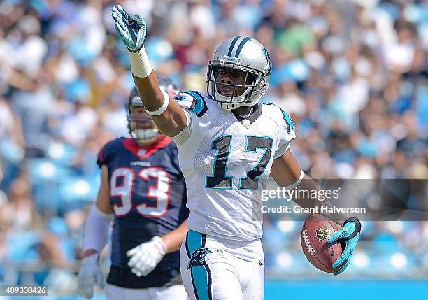 Devin Funchess of the Carolina Panthers signals after making a catch for a first down against Jared Crick of the Houston Texans during their game at...