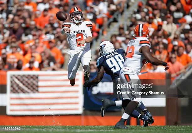 Johnny Manziel of the Cleveland Browns throws a second quarter pass behind the defense of Brian Orakpo of the Tennessee Titans at FirstEnergy Stadium...