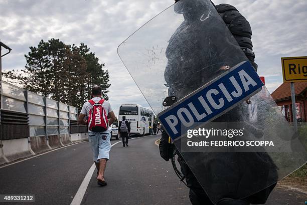 Few migrants walk after police officers let them cross the Croatian-Slovenian border in Rigonce where hundreds of migrants gathered on the Croatian...