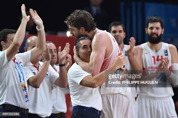 Spain's center Pau Gasol celebrates with Spain's head coach Sergio Scariolo after Spain won the final basketball match between Spain and Lithuania at...