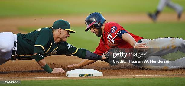 Kevin Frandsen of the Washington Nationals is tagged out at third base by Josh Donaldson of the Oakland Athletics in the top of the fifth inning at...