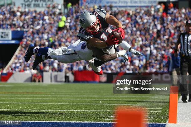Julian Edelman of the New England Patriots scores a touchdown during NFL game action as Aaron Williams of the Buffalo Bills tries to make the tackle...