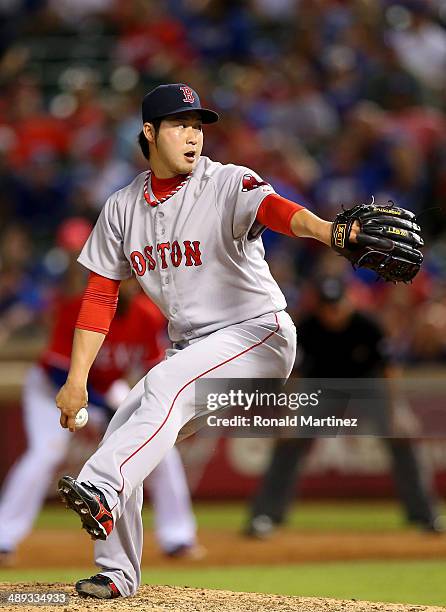 Junichi Tazawa of the Boston Red Sox throws against the Texas Rangers in the 8th inning at Globe Life Park in Arlington on May 10, 2014 in Arlington,...