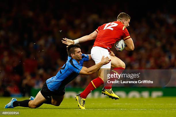 Scott Williams of Wales drives past Andres Vilaseca of Uruguay during the 2015 Rugby World Cup Pool A match between Wales and Uruguay at the...