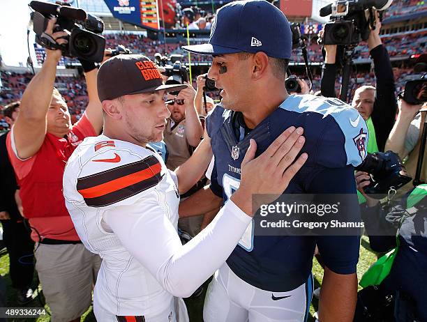 Johnny Manziel of the Cleveland Browns talks with Marcus Mariota of the Tennessee Titans after a 28-14 Cleveland win at FirstEnergy Stadium on...